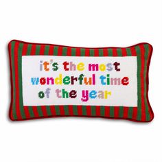 a red and green pillow with the words it's the most wonderful time of the year