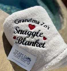 a white towel with the words grandma 101's smugle blanket on it