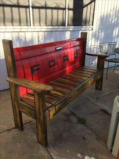 a wooden bench sitting on top of a cement ground next to a building with windows