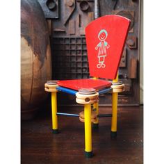 a child's chair with a stick figure painted on it