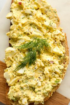 an egg salad with cheese, yogurt and dill on toasted bread