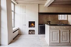 a kitchen with an oven, sink and stove in it's center island next to a window