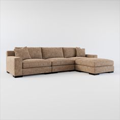 a large sectional couch with pillows on the top and bottom end, in front of a white background