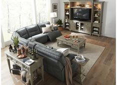 a living room filled with furniture and a flat screen tv on top of a wooden table