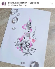 a card with an image of a lighthouse and flowers on it, surrounded by crystals