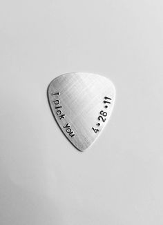 a guitar pick with the words today i love you now on it's side