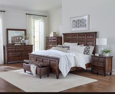 a bedroom scene with focus on the bed and dresser