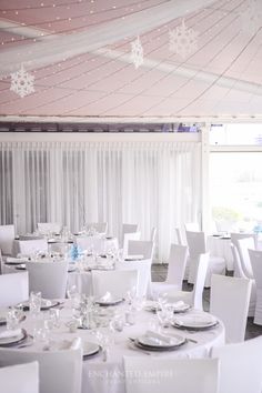 tables and chairs are set up for a wedding reception in a tented area with white drapes