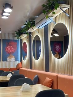 an empty restaurant with round mirrors on the wall