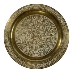 a gold plate with intricate designs on it