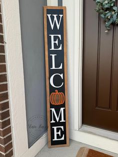 a welcome sign sitting next to a door