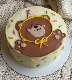 a birthday cake decorated with a teddy bear