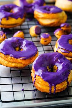 glazed air fryer donuts with purple icing on a cooling rack, ready to be eaten