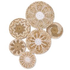 four woven coasters with white and brown designs on the top, one in the middle