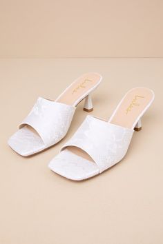 You'll be obsessed with the amount of compliments coming your way when you step out wearing the Lulus Maeler White Lace High Heel Slide Sandals! These ultra-romantic, lace-covered heels feature a trendy square footbed and an extra-wide vamp strap. A sculpted kitten heel completes the sleek slide-on design. 2. 5" sculpted heel. Lightly cushioned insole. Felted rubber sole has nonskid markings. Man made materials. Imported. Lulus | Maeler White Lace High Heel Slide Sandal Heels | Size 9. Low Heel Summer Wedding Guest Heels, Low Heel Heels For Wedding Guest In Summer, Low Heel Wedding Guest Heels For Summer, Summer Wedding Guest Low Heel Shoes, Summer Wedding Guest Low Heels, Summer Bridal Shower Block Heel Shoes, Summer Bridal Shower Block Heels, Feminine Block Heel Wedding Shoes For Summer, Feminine Summer Wedding Shoes With Block Heel