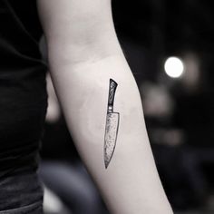 a knife tattoo on the left arm