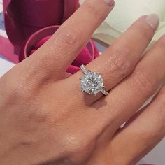 a woman's hand with a diamond ring on it