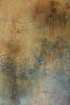 an abstract painting with blue and brown flowers in the middle, against a gold background