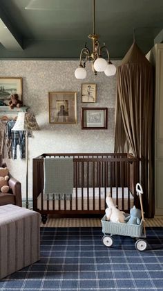 a baby's room with a crib, rocking chair and pictures on the wall