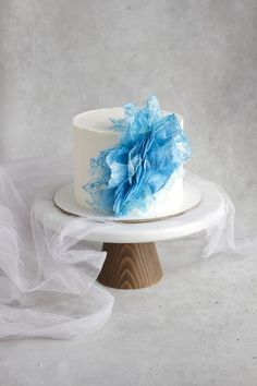 a white cake with blue flowers on top