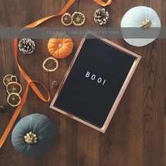 a wooden table topped with pumpkins and other decorations