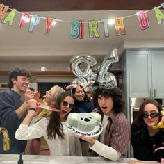 a group of people standing around a cake