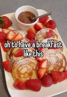 pancakes and strawberries on a white plate with chocolate sauce in the middle that says, oh to have a breakfast like this