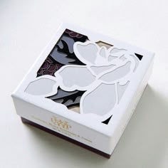 a white box with cut out flowers on it