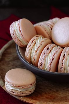 a plate filled with macaroons and cookies on top of a red table cloth