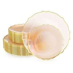 two plates with gold rims are stacked on top of each other