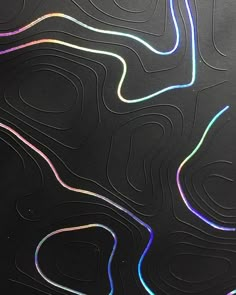 an abstract black background with multicolored lines and curves on the bottom right corner