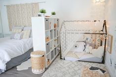 a bedroom with two beds and a baby crib