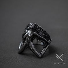 If a ring looks like it was made by a devil, it's called a "devil girl ring". A stylized picture of a devil girl is often found on this ring. It has wings and other devilish features. With careful attention to detail, this accessory gives off a rebellious and daring vibe, making it a statement piece for people who like to dress in a bold and unique way. This devil girl ring is a one-of-a-kind accessory that adds a touch of rebellious style to any outfit. It's an eye-catching piece of jewelry for Gothic Wedding Rings, Devil Girl, Gothic Ring, Geek Jewelry, Gothic Rings, Paper Stars, Tree Of Life Pendant, Rose Quartz Gemstone, Creating Jewelry