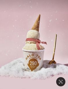 two scoops of ice cream in a cup on top of snow