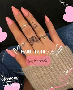 a woman's hand with tattoos on it and hearts around her fingers in the background