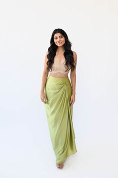 Experience the understated elegance of our Satin Drape Skirt. Crafted with a fitted waistband for a seamless silhouette fit and finished with a timeless drape, this piece is crafted from a luxuriously soft silk satin fabric, perfect for a flowy, feminine look. Features: Zipper and hook closure Fitted waistband Included in purchase: Pista Drape Skirt Satin Dhoti Skirt, Side Drape Skirt, Satin Skirt Outfit Indian, Satin Skirt Design, Elegant Fitted Draped Skirt With Traditional Drape, Saree Skirt Drape, Elegant Fitted Traditional Draped Skirt, Elegant Silk Skirt With Traditional Drape, Silk Ruched Draped Skirt