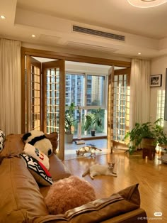 a living room filled with lots of furniture and large doors leading to an outside patio