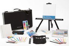 an artist's easel and supplies including watercolors, pens, markers, pencils, paintbrushes on a white background