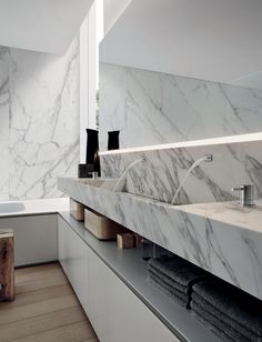 a bathroom with marble counter tops and sinks