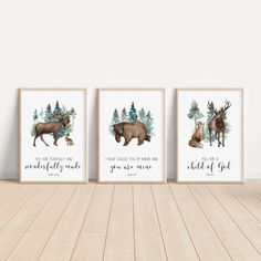 three framed art prints with animals and trees on the wall in a white walled room