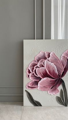 a pink flower painted on a white canvas