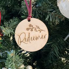 a wooden ornament hanging from a christmas tree with the word'pedener'written on it