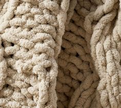 the texture of a blanket is made up of thick, wavy knits and crochet