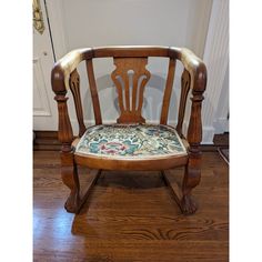 a wooden chair sitting on top of a hard wood floor next to a white door