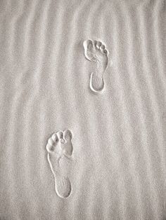 two footprints are shown in the sand