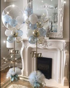 blue and white balloons in front of a fireplace