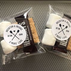 two bags filled with marshmallows sitting on top of a metal counter next to each other