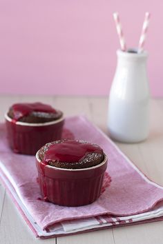 two desserts sitting on top of a pink napkin