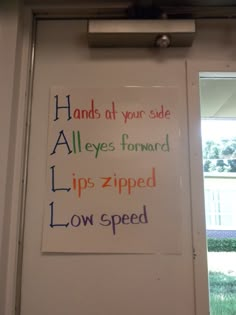 a sign on the wall that says hand at your side all eyes forward tips zipped low speed