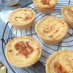 several small pies are cooling on a wire rack